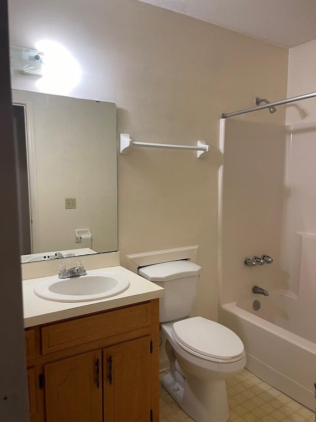 full bathroom with vanity, bathing tub / shower combination, toilet, and a textured ceiling