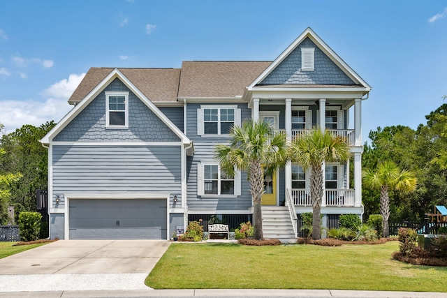 view of front of property with an attached garage, concrete driveway, a front yard, and a balcony
