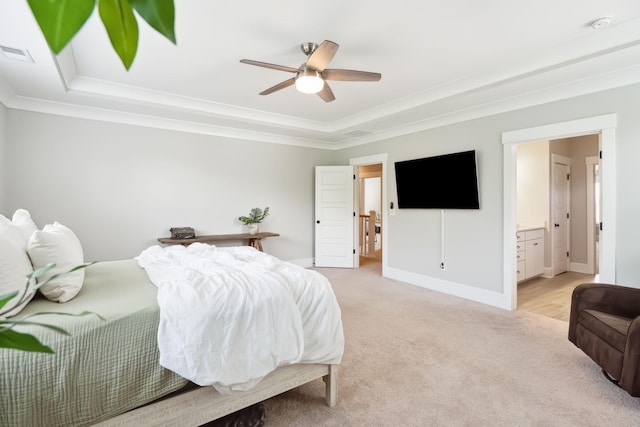 bedroom with visible vents, a tray ceiling, light colored carpet, and crown molding