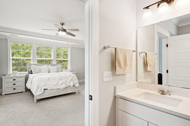 ensuite bathroom with ensuite bathroom, visible vents, baseboards, ceiling fan, and vanity