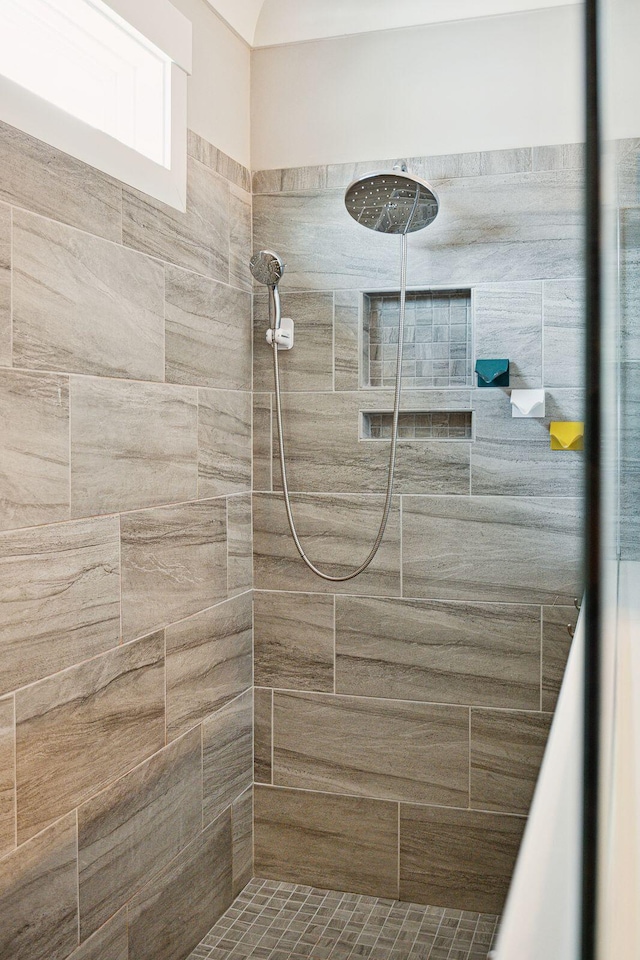 bathroom with tiled shower