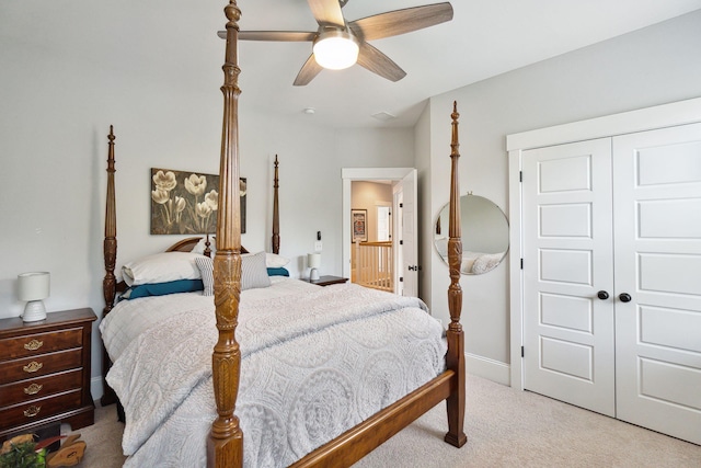 bedroom featuring a closet, light colored carpet, and ceiling fan