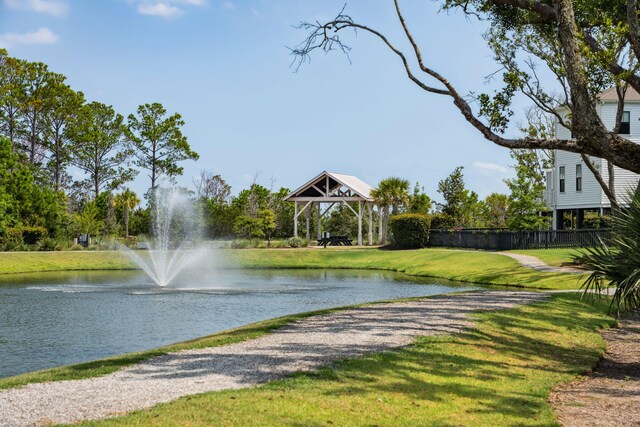 property view of water with fence and a gazebo