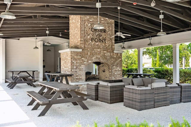 view of patio featuring an outdoor living space with a fireplace and a ceiling fan