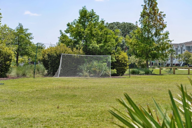 view of home's community featuring fence