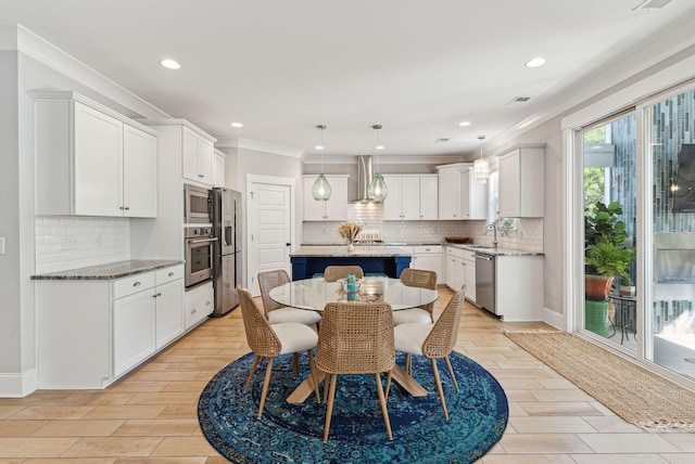 dining room featuring recessed lighting, light wood-style floors, visible vents, and ornamental molding