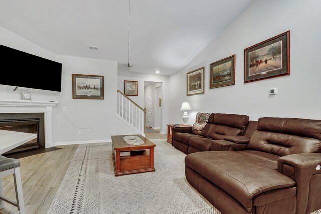 516 Yellow Leaf Ln, Summerville, SC 29486 - living area featuring visible vents, lofted ceiling, light wood-style flooring, stairway, and baseboards