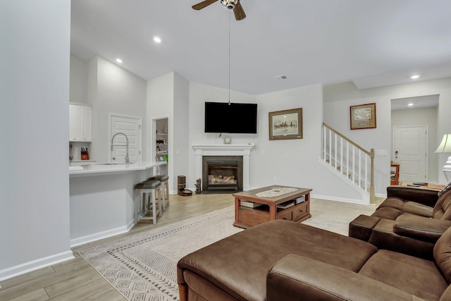 516 Yellow Leaf Ln, Summerville, SC 29486 - living area featuring baseboards, stairway, recessed lighting, light wood-style flooring, and a glass covered fireplace