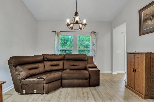 living room featuring light hardwood / wood-style flooring, vaulted ceiling, and a chandelier