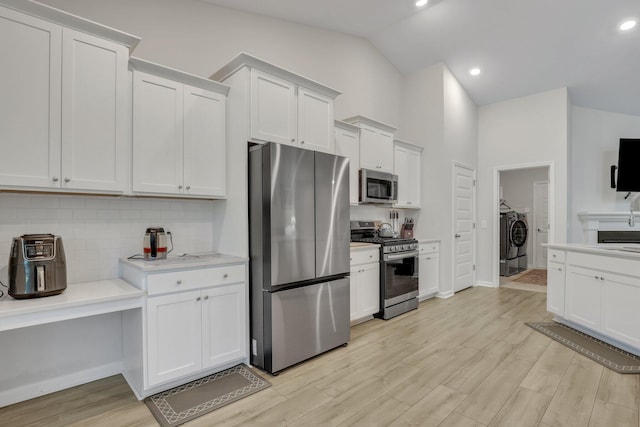 516 Yellow Leaf Ln, Summerville, SC 29486 - kitchen with light wood finished floors, washer and clothes dryer, light countertops, decorative backsplash, and appliances with stainless steel finishes