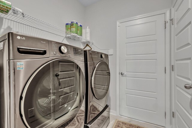 washroom with independent washer and dryer