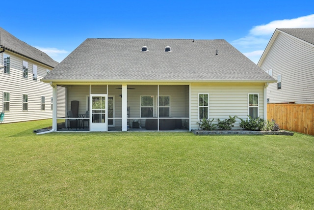 back of house featuring a yard and a sunroom