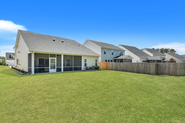 516 Yellow Leaf Ln, Summerville, SC 29486 - rear view of house featuring a lawn, a shingled roof, a sunroom, and fence