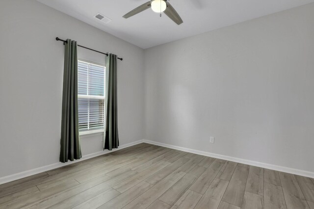 unfurnished room featuring light wood-type flooring and ceiling fan