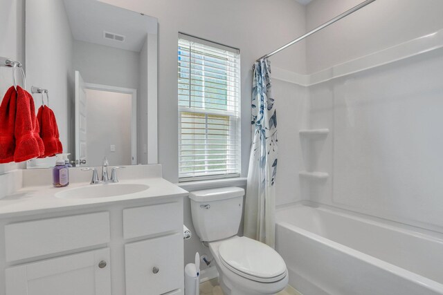 full bathroom featuring shower / bath combo, toilet, and vanity