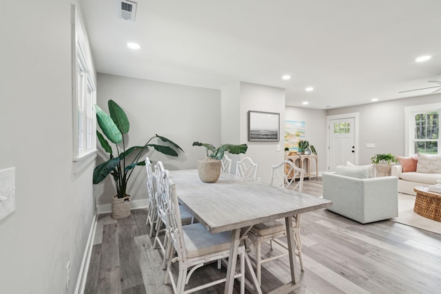 dining area with light wood-style flooring, visible vents, baseboards, and recessed lighting