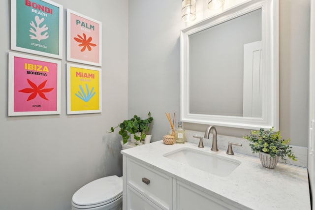 bathroom with toilet and vanity