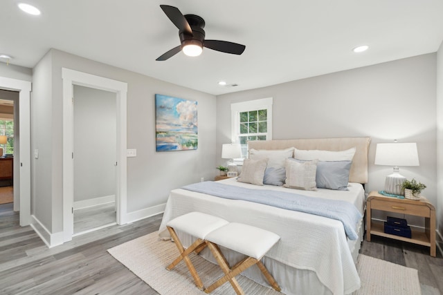 bedroom featuring recessed lighting, wood finished floors, and baseboards