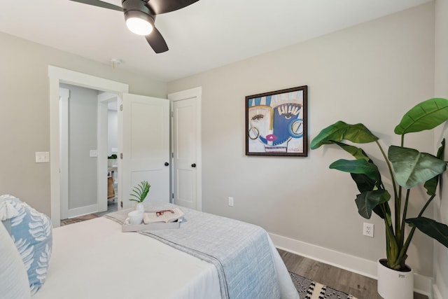 bedroom featuring ceiling fan, baseboards, and wood finished floors