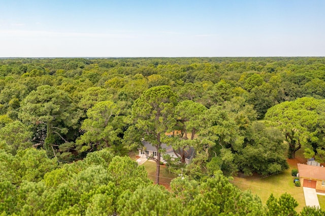 bird's eye view with a wooded view