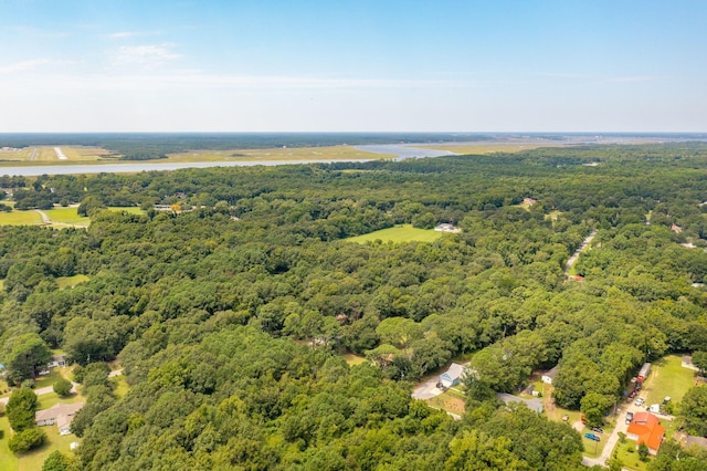 drone / aerial view featuring a wooded view