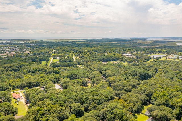 birds eye view of property featuring a wooded view