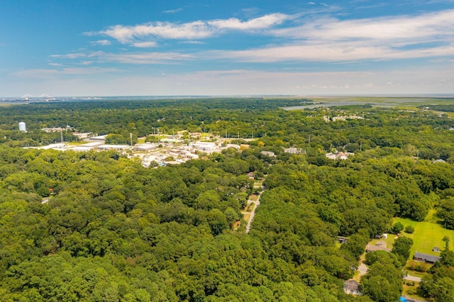 birds eye view of property featuring a forest view