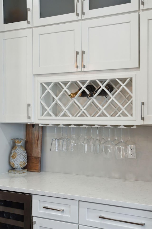 bar featuring decorative backsplash, a dry bar, and wine cooler