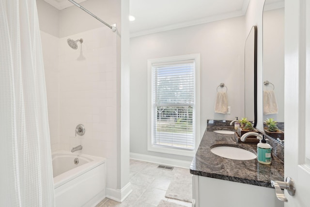 bathroom featuring shower / bath combination with curtain, a sink, ornamental molding, and visible vents