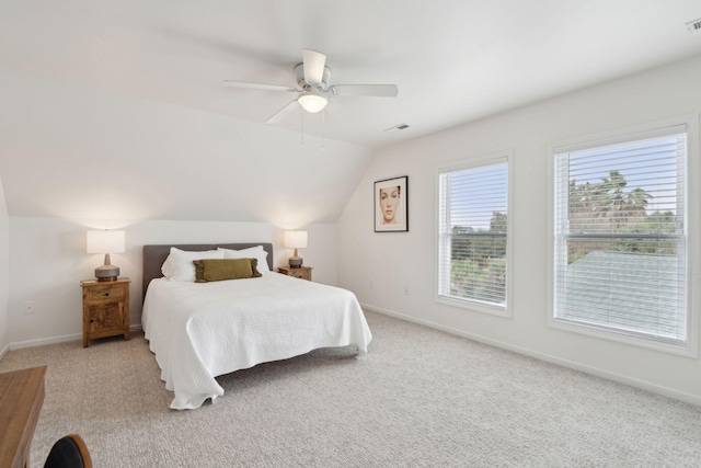 carpeted bedroom featuring a ceiling fan, baseboards, lofted ceiling, and visible vents