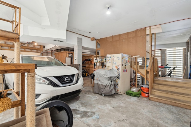 garage with visible vents and freestanding refrigerator