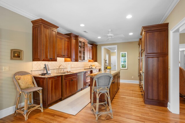 kitchen featuring light wood-type flooring, ceiling fan, and sink