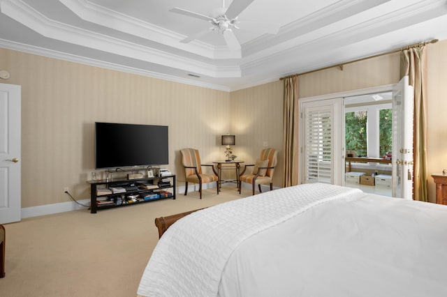 bedroom with crown molding, light colored carpet, a tray ceiling, and ceiling fan