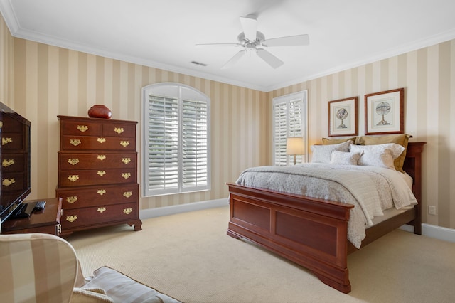 carpeted bedroom with ceiling fan and crown molding