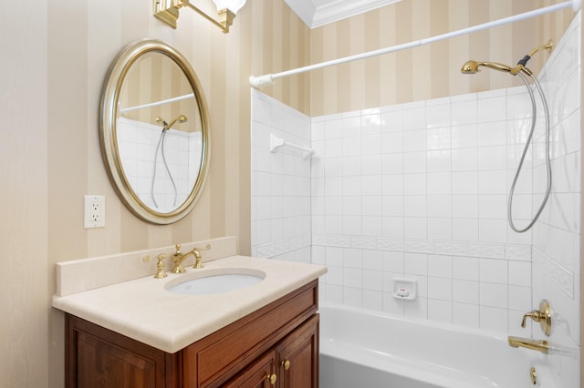 bathroom featuring ornamental molding, vanity, and tiled shower / bath combo