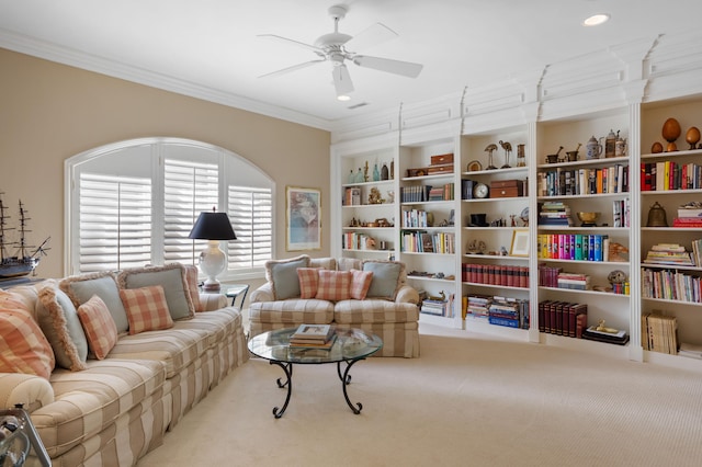 carpeted living room with ceiling fan and crown molding