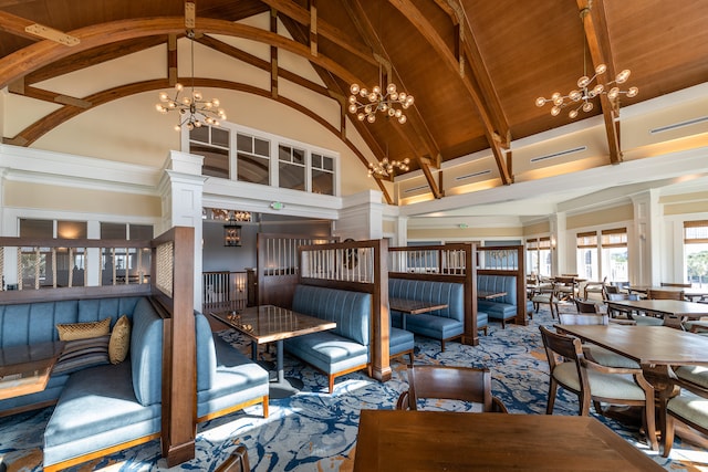 interior space with decorative columns, high vaulted ceiling, an inviting chandelier, and beam ceiling