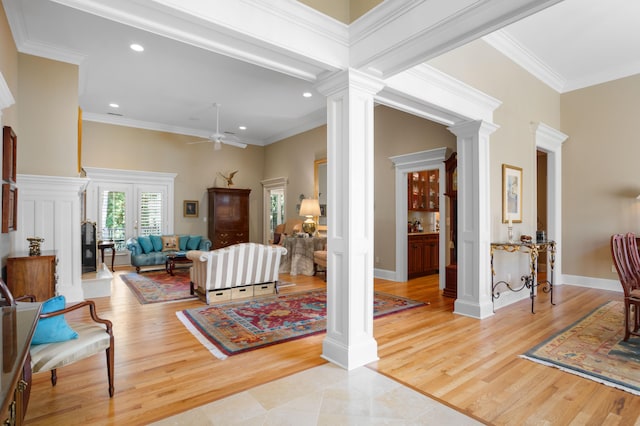 living room featuring ornamental molding, ornate columns, and ceiling fan