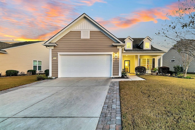 view of front of house with a garage and a lawn