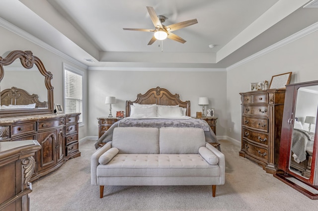 carpeted bedroom with a tray ceiling and ceiling fan