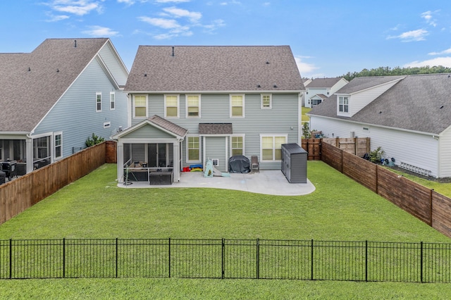 back of property featuring a sunroom, a patio, and a lawn