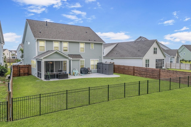 rear view of house featuring a sunroom, a yard, and a patio