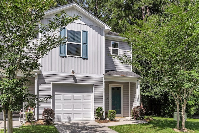 271 Jackson St, Goose Creek, SC 29445 - view of front of home featuring an attached garage, concrete driveway, board and batten siding, a front lawn, and roof with shingles