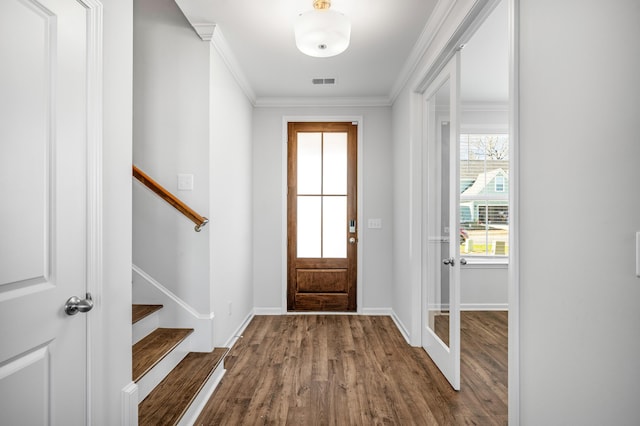 entryway featuring hardwood / wood-style floors and crown molding