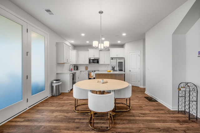 dining space featuring a chandelier, dark hardwood / wood-style flooring, and sink