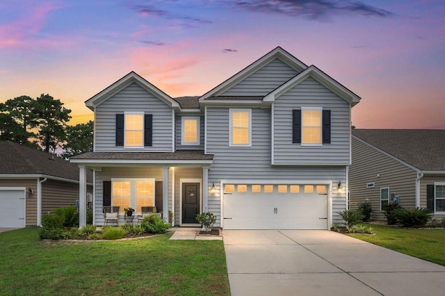 3438 Great Egret Dr, Johns Island, SC 29455 - view of front of property featuring an attached garage, covered porch, driveway, and a lawn