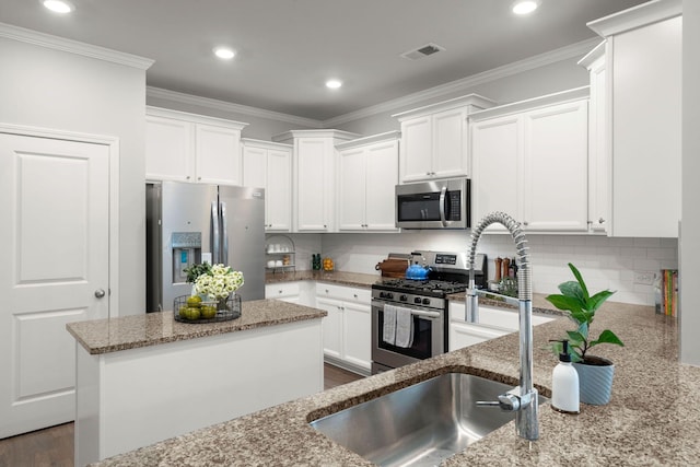 3438 Great Egret Dr, Johns Island, SC 29455 - kitchen with light stone countertops, tasteful backsplash, white cabinetry, visible vents, and appliances with stainless steel finishes