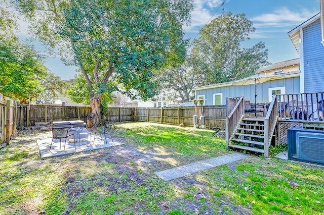 view of yard with a wooden deck and a patio