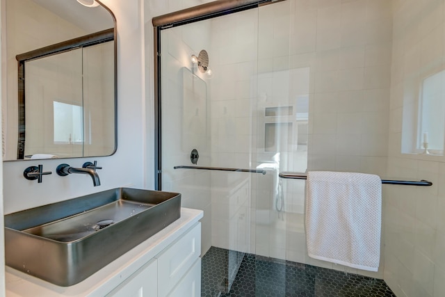 bathroom featuring vanity, tile patterned flooring, and a shower with door