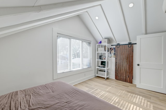 unfurnished bedroom with light hardwood / wood-style floors and lofted ceiling